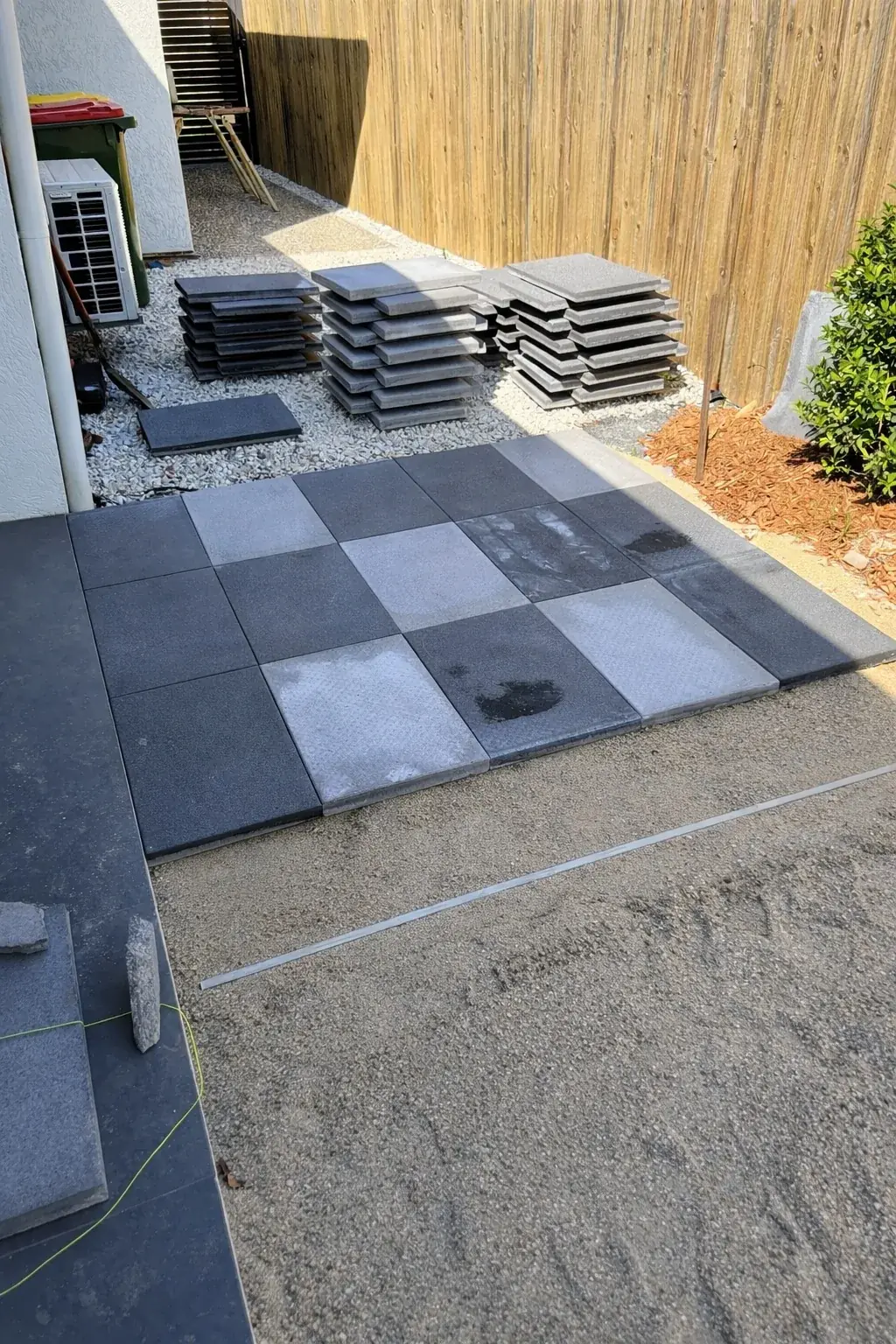 Extended paved courtyard and screening plants creating an outdoor living area at a Cairns home — before