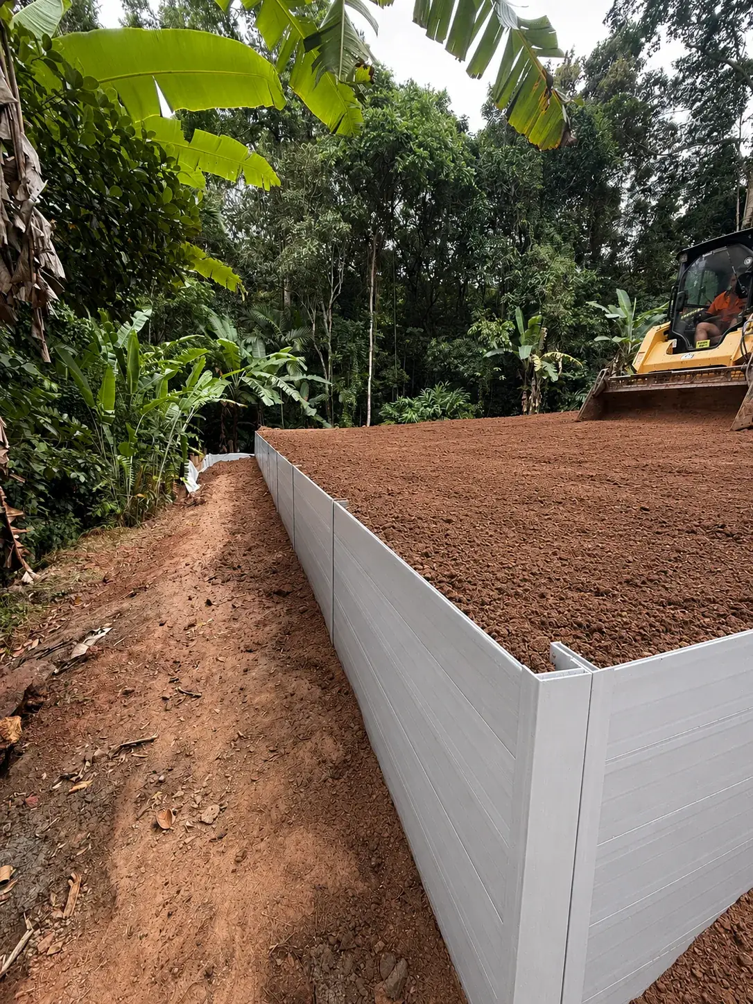 Completed Super Sleeper retaining wall reclaiming sloping land at a Cairns property