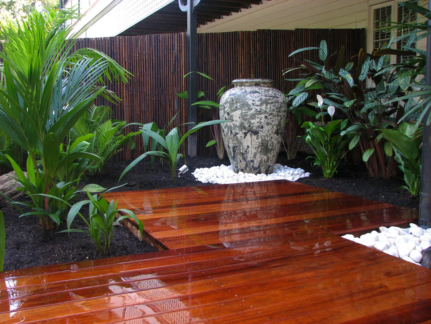 Hardwood entry deck, feature urn and tropical garden landscaping at a Cairns home