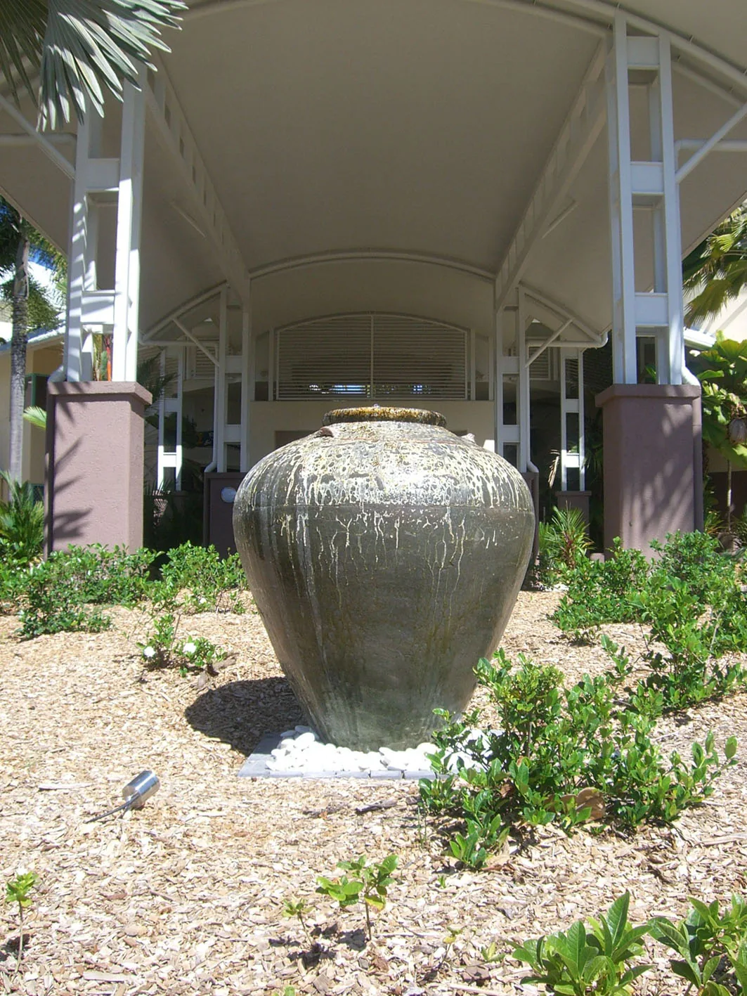 Converted large urn water feature with surrounding planting at Trinity Beach